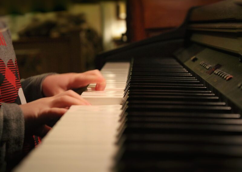 a pianist with small hands is playing piano