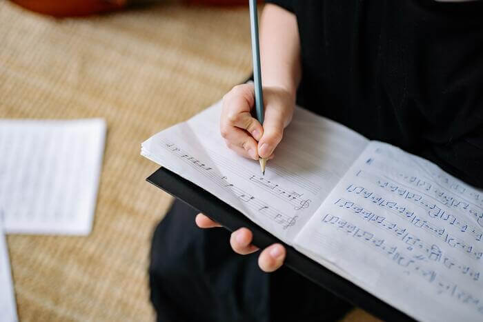 a musician is writing music notation