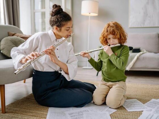 an instructor and her student are playing flute duets