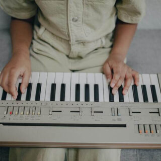 a person is playing a 61 key keyboard