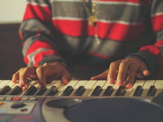 a beginner is playing on a 49-key keyboard