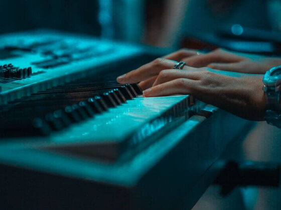 a pianist is playing on a cheap touch sensitive keyboard